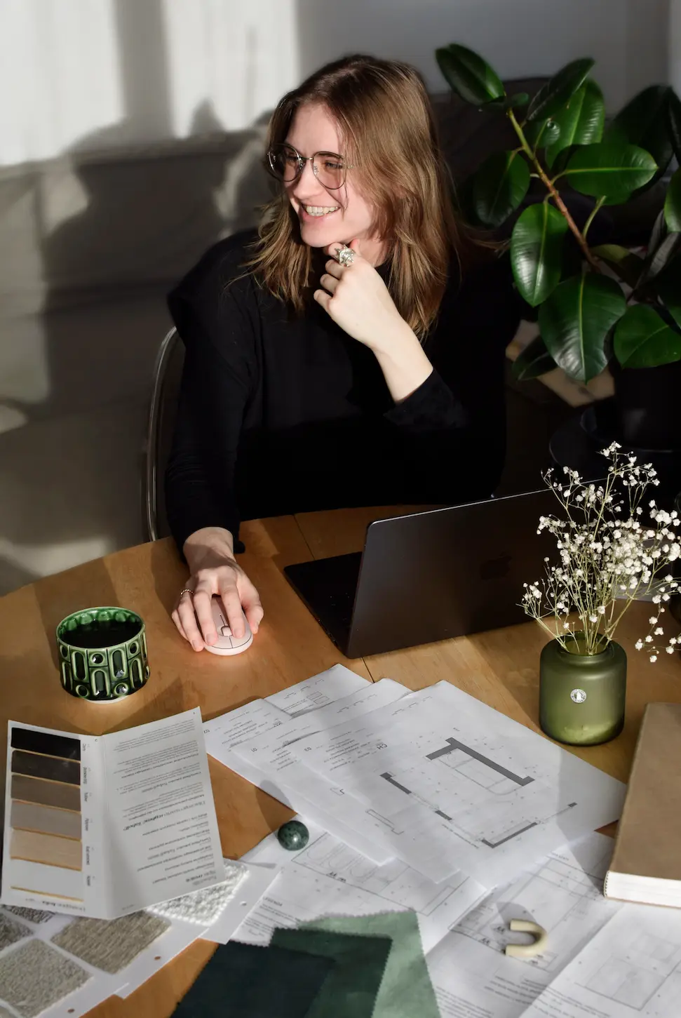 Architekt Zuzanna Chamera przy biurku z planami i próbkami materiałów
